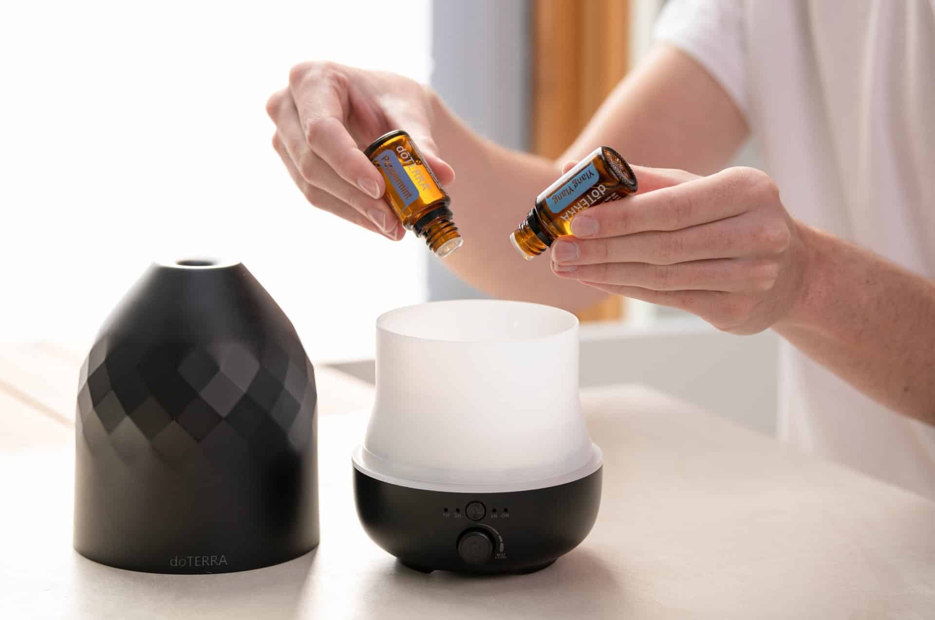 essential oils being put in a diffuser